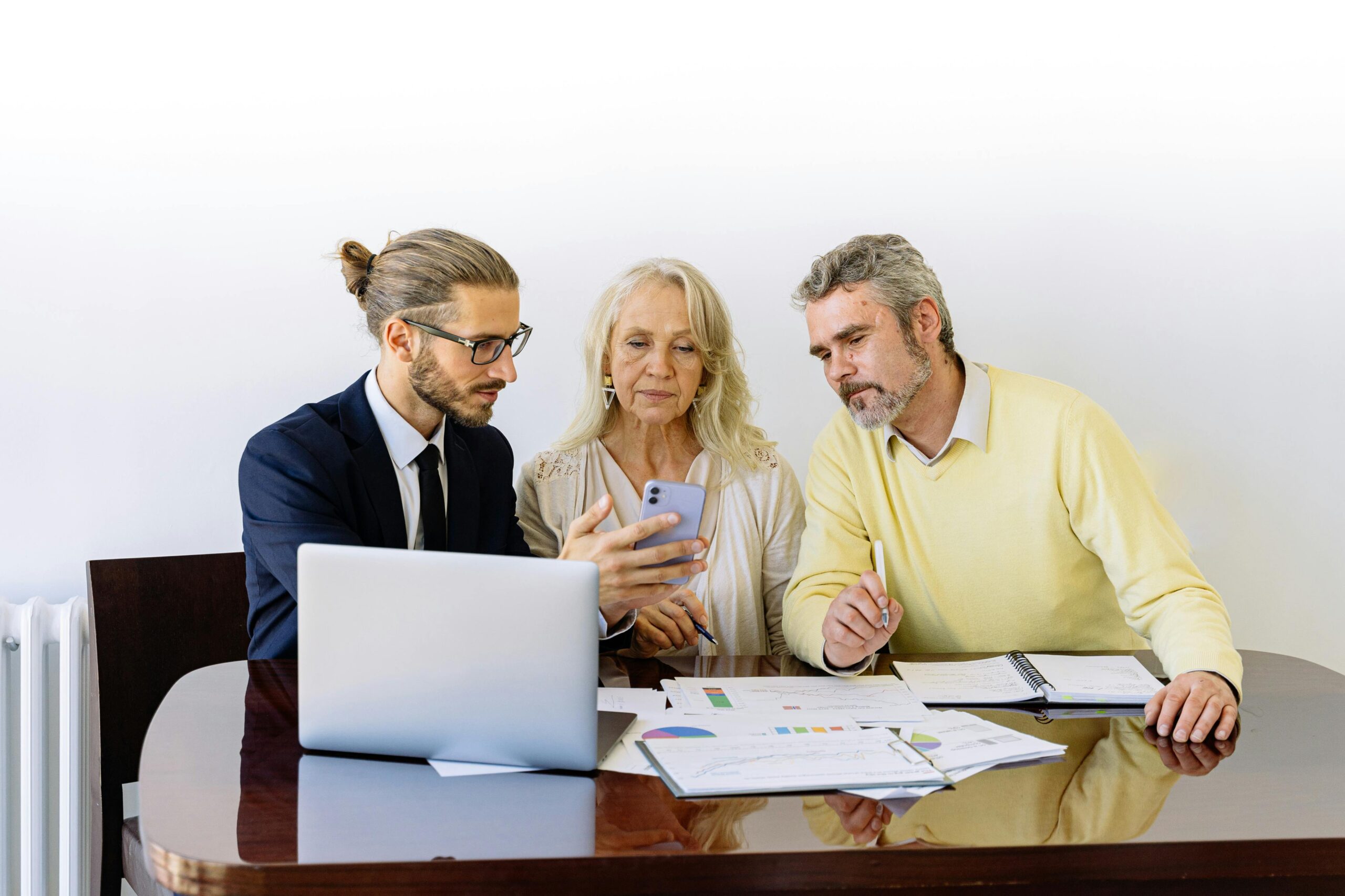 A salesperson talking to a man and woman while showcasing customer acquisition strategies.